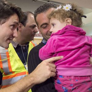 Prime Minister Justin Trudeau, left, greets Madeleine Jamkossian, right, and her father Kevork Jamkossian, refugees fleeing the Syria, during their arrival at Pearson International airport, in Toronto, on Friday, Dec. 11, 2015. The first Canadian government plane carrying Syrian refugees arrived in Toronto late Thursday. (Nathan Denette/The Canadian Press via AP) MANDATORY CREDIT/NSD605/944118459854/MANDATORY CREDIT/1512111107