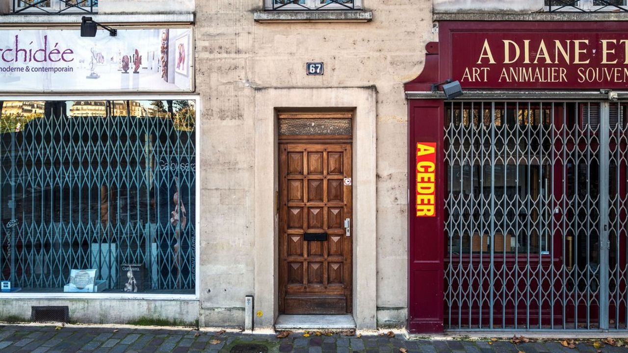 Des commerces aux rideaux baissés dans une rue parisienne. En mars 2020, une boutique fermée avait le droit à 1.500 euros par mois ; un an plus tard, la somme peut monter à 10.000 euros