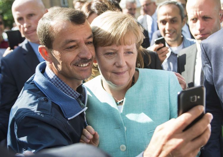 La chancelière allemande pose pour un selfie avec un réfugié.