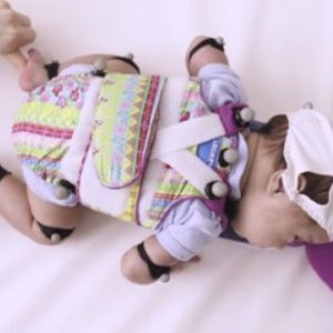 Pour étudier les déplacements du tout jeune bébé dont la tête représente un tiers de son poids corporel, l'équipe de chercheurs a mis au point une sorte de miniskateboard doté de roulettes et d'un support pour sa tête.