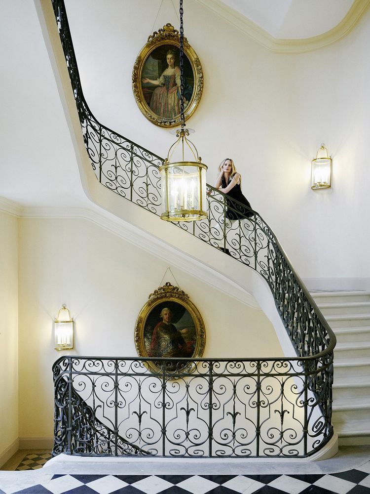 Lauren Santo Domingo dans l'éscalier de l'hôtel particulier du XVIIIe siècle dont elle occupe deux étages