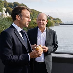 Le chancelier allemand, Olaf Scholz, et le président français, Emmanuel Macron, dégustent un sandwich au poisson lors d'une promenade le long de l'Elbe, à Hambourg.