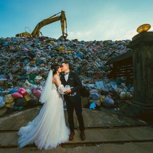 La photo prise le 14 octobre 2023 par Owen Kang montre Iris Hsueh et son fiancé Ian Ciou posant en face d'une montagne de déchet de la décharge de Puli, dans le comté de Nantou à Taïwan.