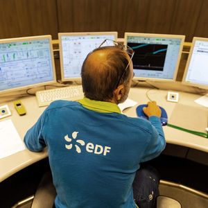 An operator works in the control room at the third-generation European Pressurised Reactor project (EPR) nuclear reactor of Flamanville, Normandy on June 14, 2022. EDF is to start the Flamanville EPR in 2023 after countless delays and setbacks. (Photo by Sameer Al-DOUMY / AFP)
